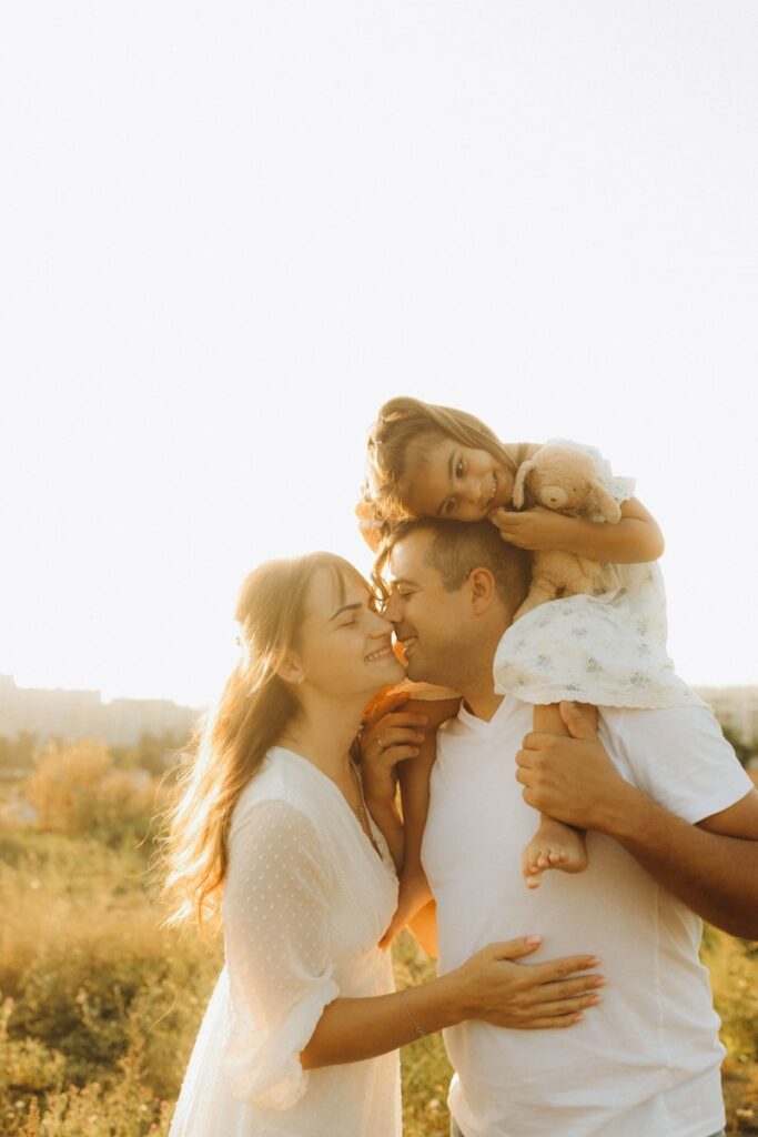 A man holding a little girl in his arms